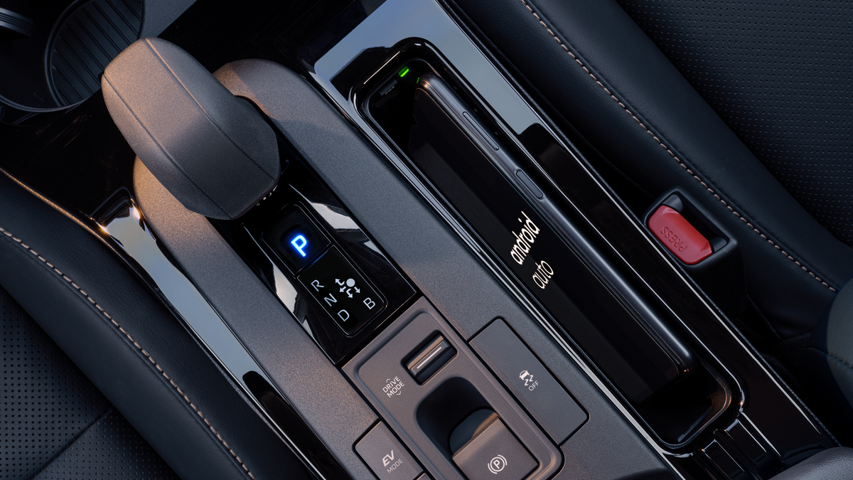 Center console of a 2027 Toyota Prius with wireless phone charging pad and shifter