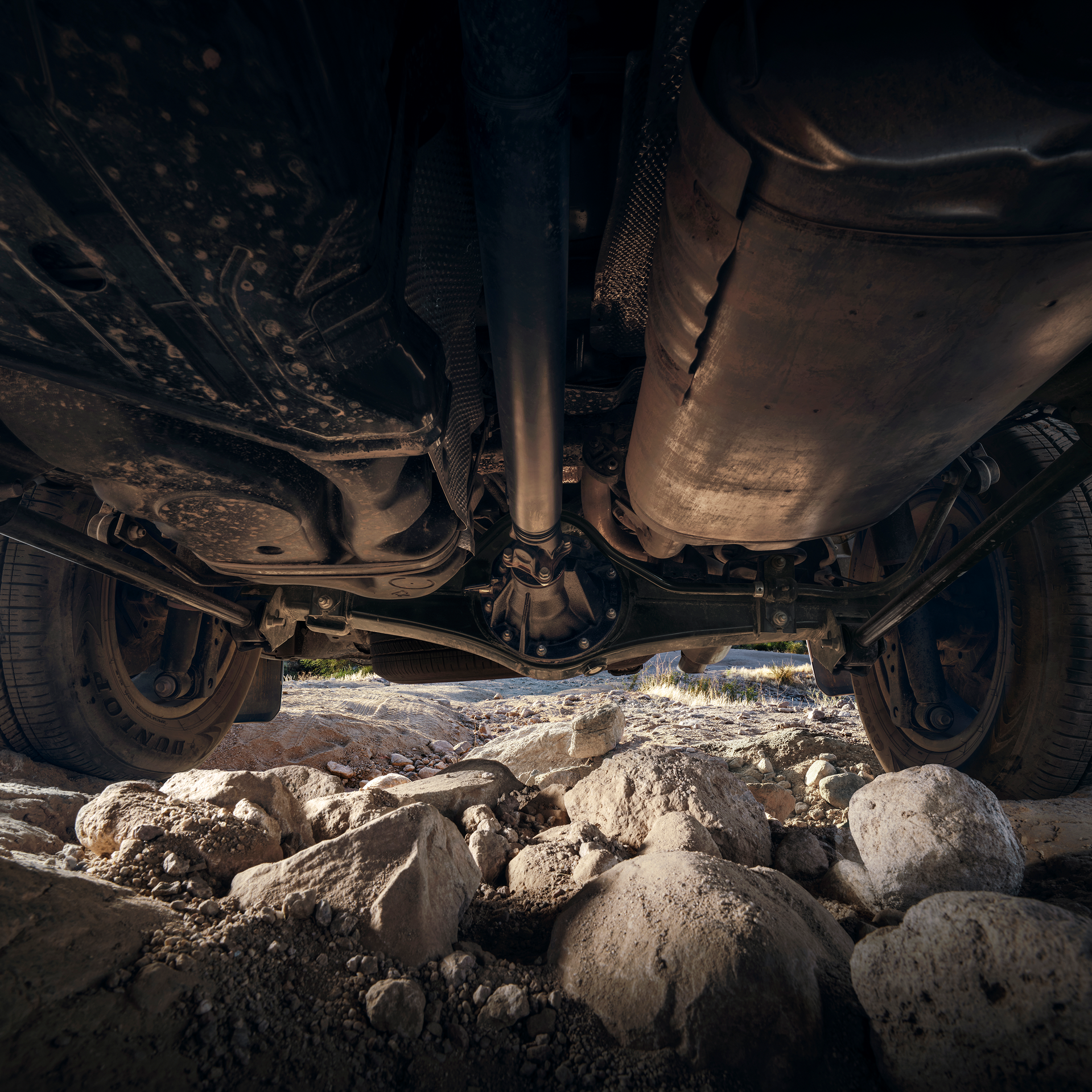 Underside of a Toyota Land Cruiser above rocks on a trail